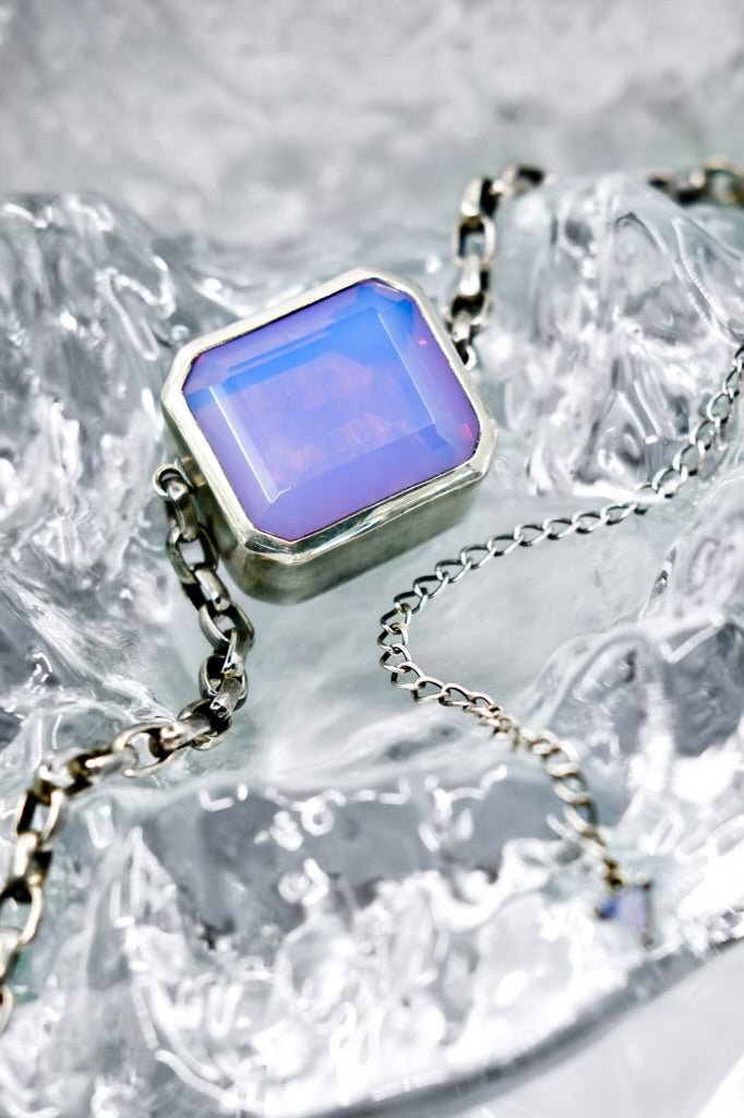 Necklace with a periwinkle gemstone on a textured surface