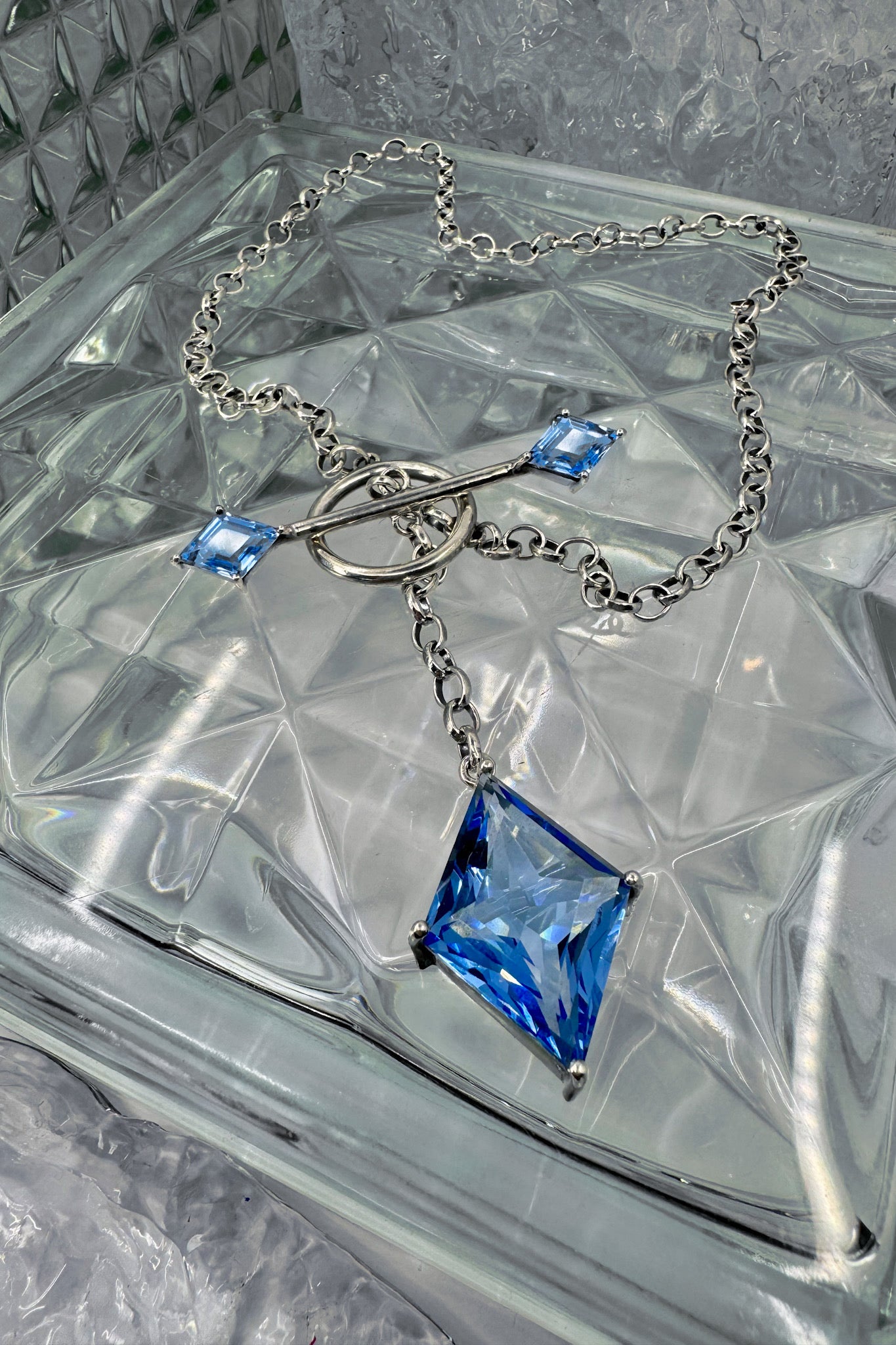 Blue stone necklace on a textured background. 