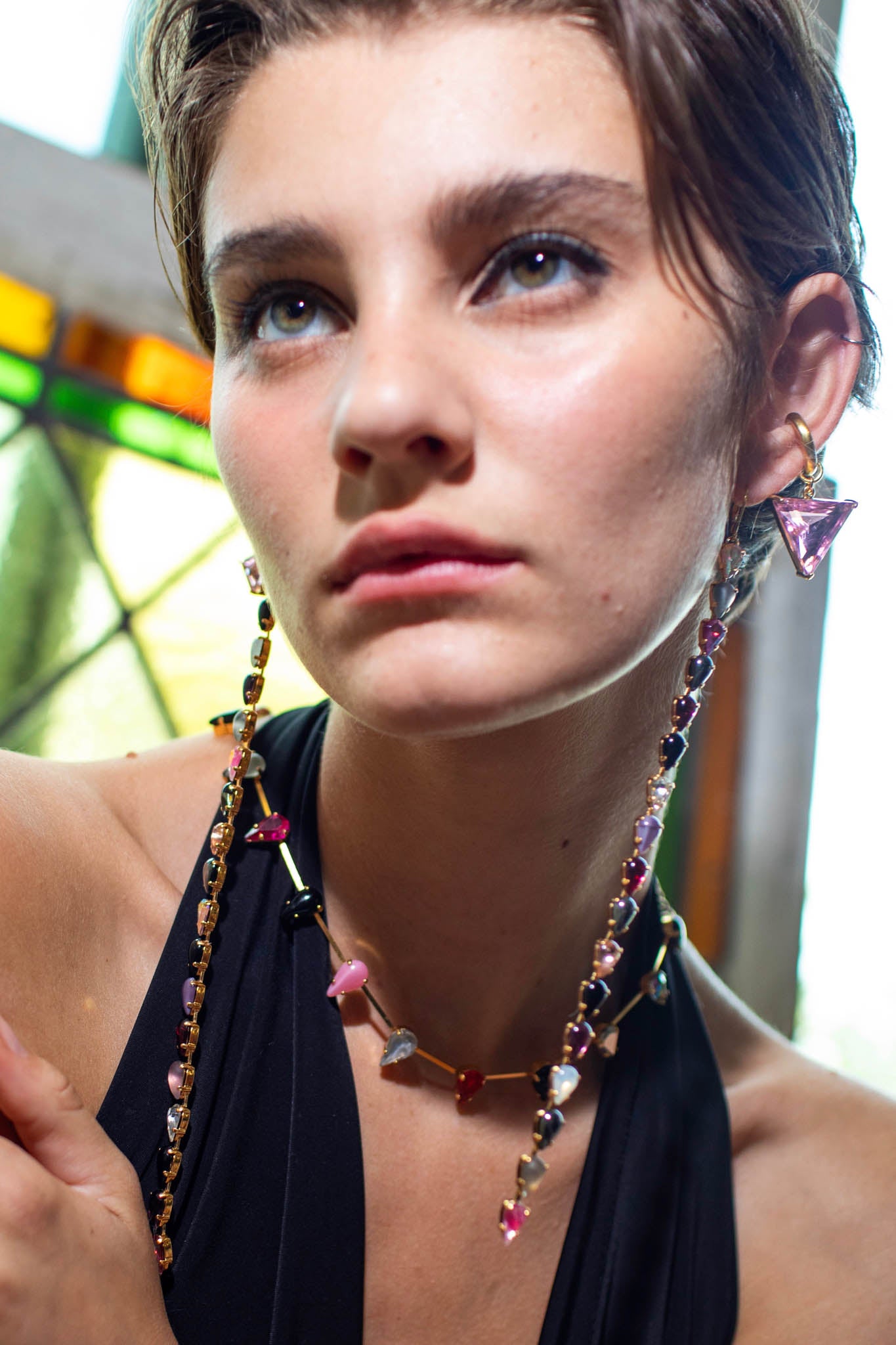 Close-up of a woman wearing colorful jewelry with a blurred background